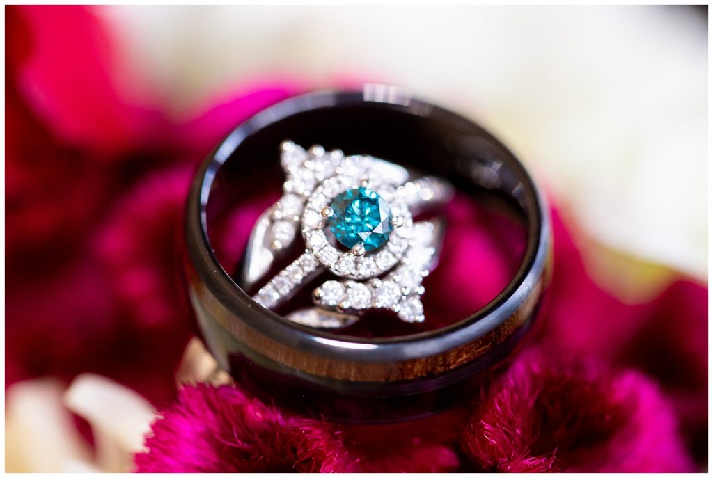 Teal engagement ring and men's wedding band.