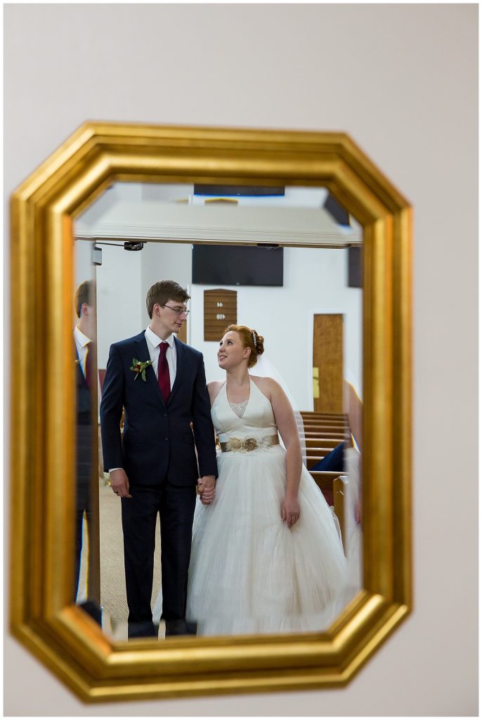 Bride and groom reflected in a mirror