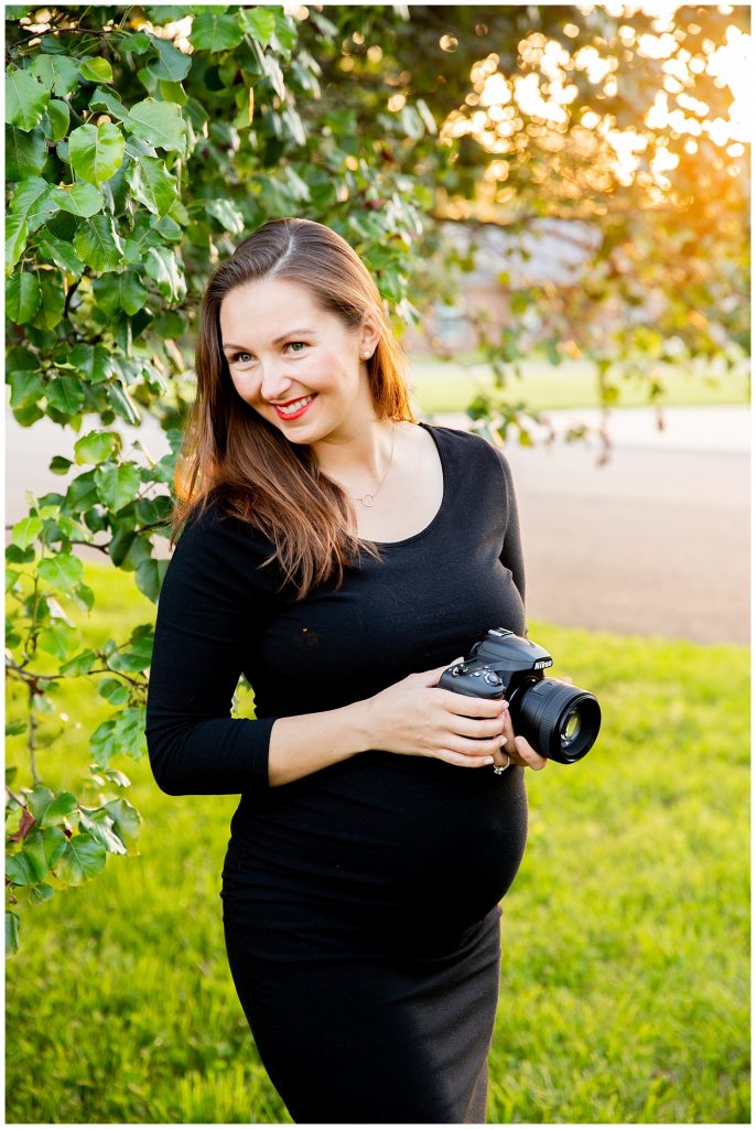 pregnant woman smiling and posing with camera