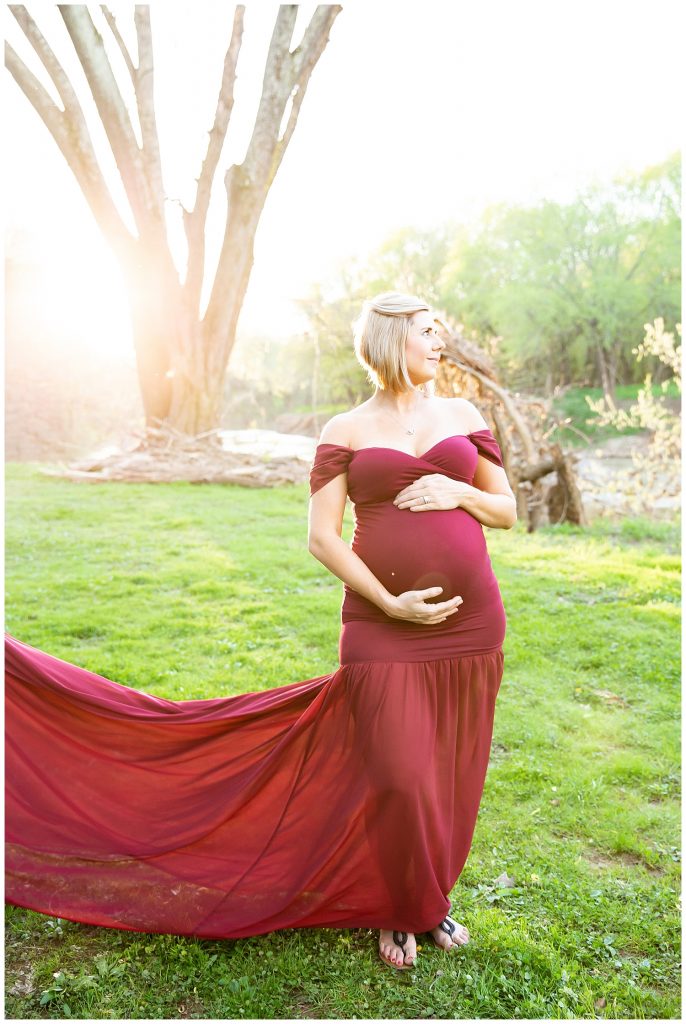 pregnant woman holding belly with glowing sun