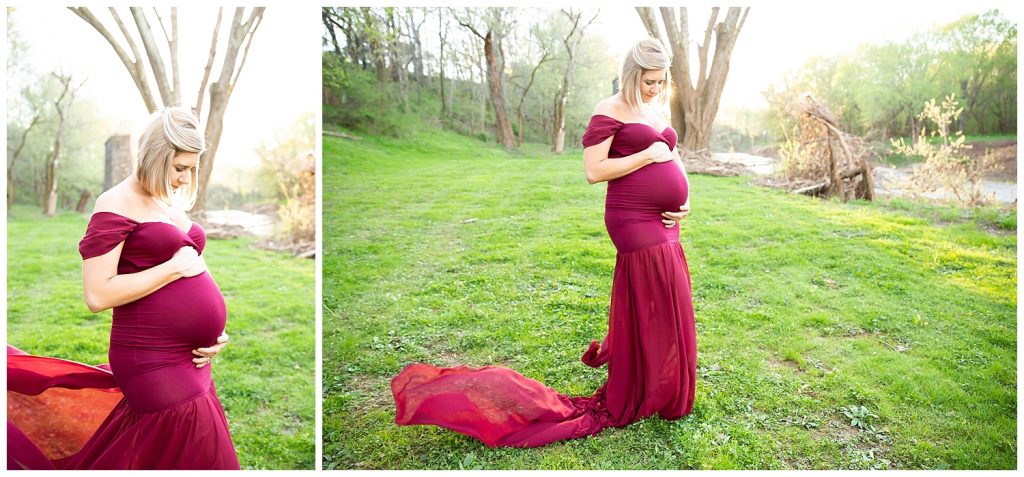 pregnant woman in long red dress looking at belly