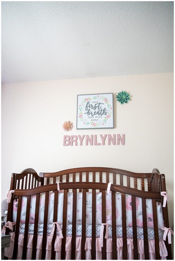 crib and baby name on wall