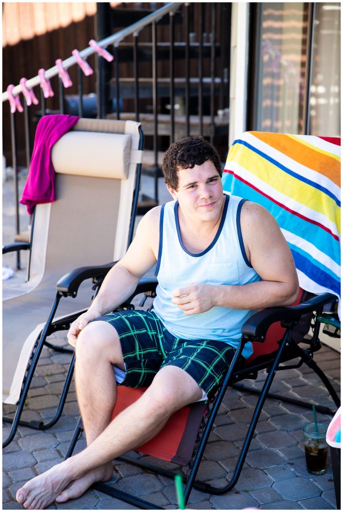 man sitting by a pool