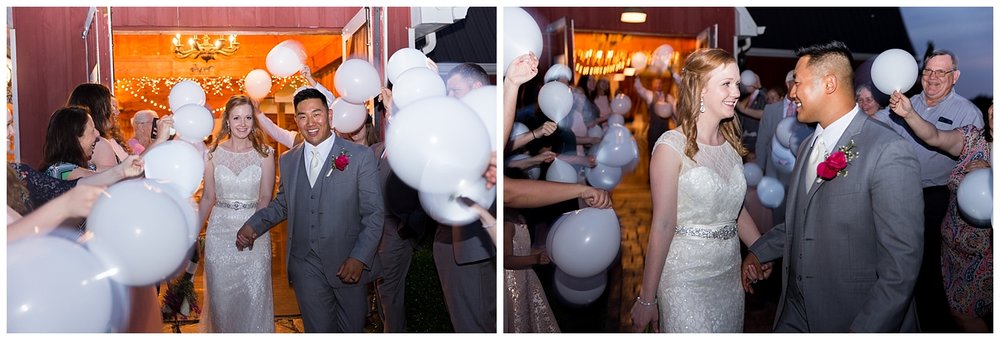 bride and groom leaving wedding surrounded by balloons