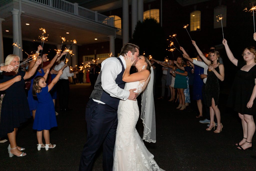 Bride-and-groom-kiss-sparkler-exit-night-reception