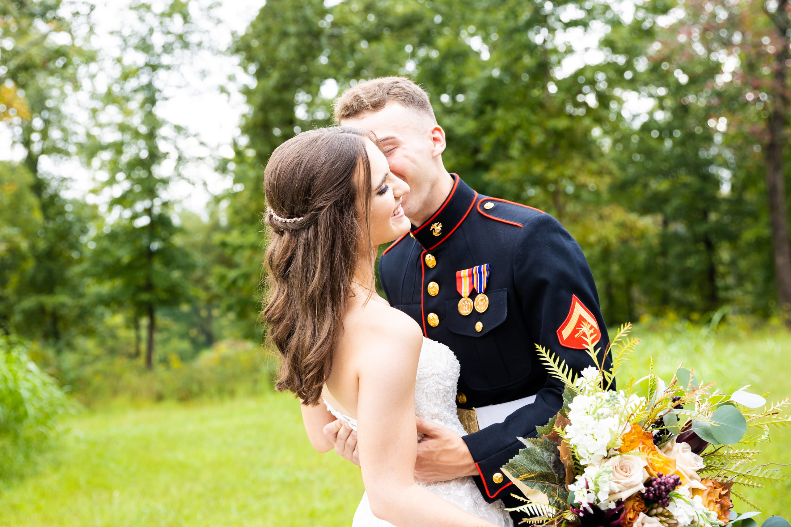 Bride and groom in military attire kissing