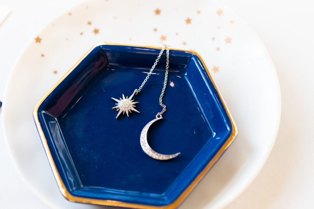 silver celestial jewelry on blue tray