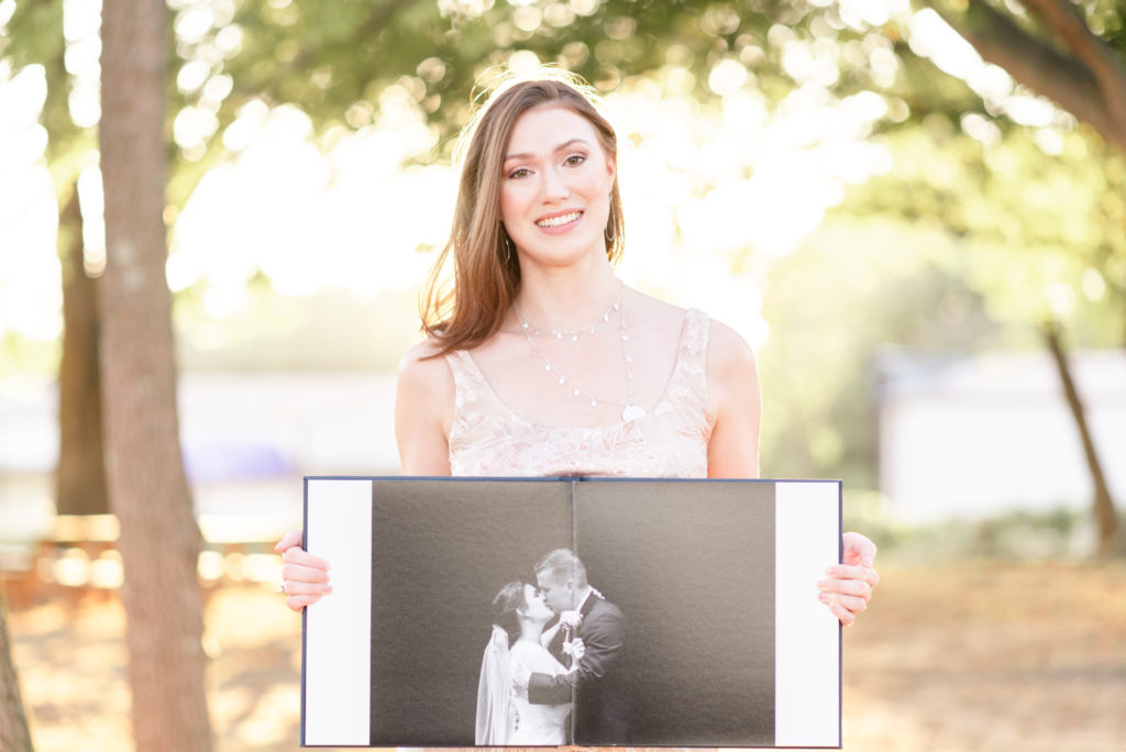photographer holding a wedding album open